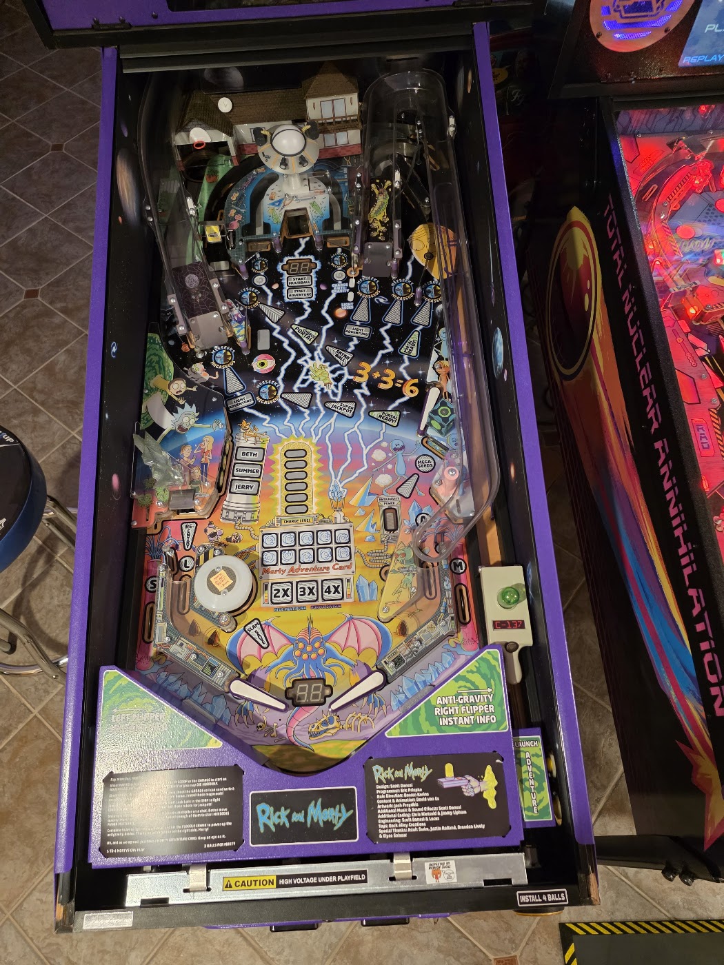 The Rick and Morty pinball playfield, with its ramps, ship, targets and flippers